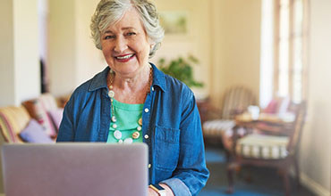 Elderly woman using her laptop